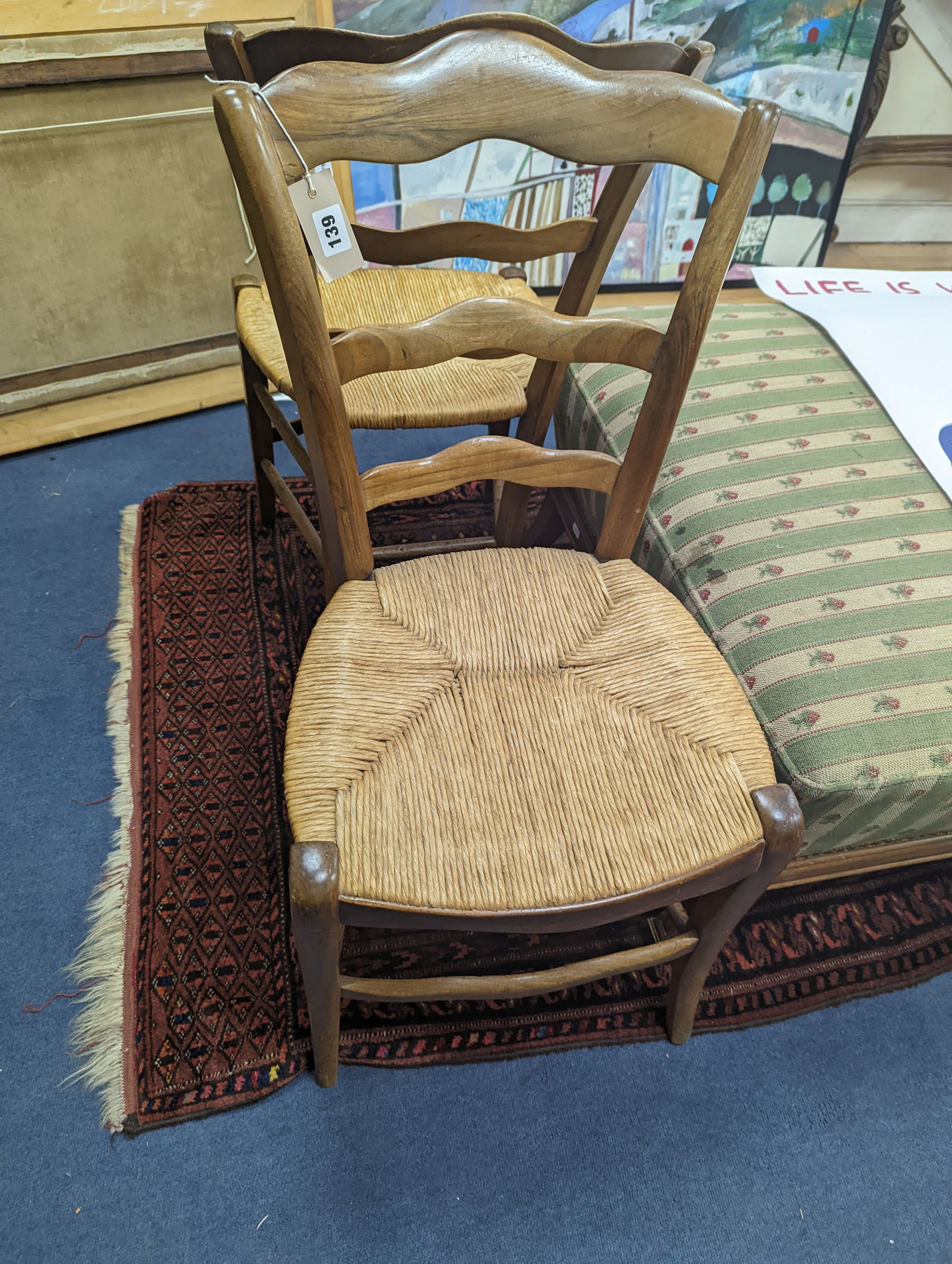 A pair of 19th century French rush seat walnut dining chairs